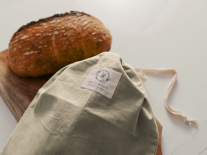 Bee's Wrap Bread Bag closed with a loaf of bread in the background