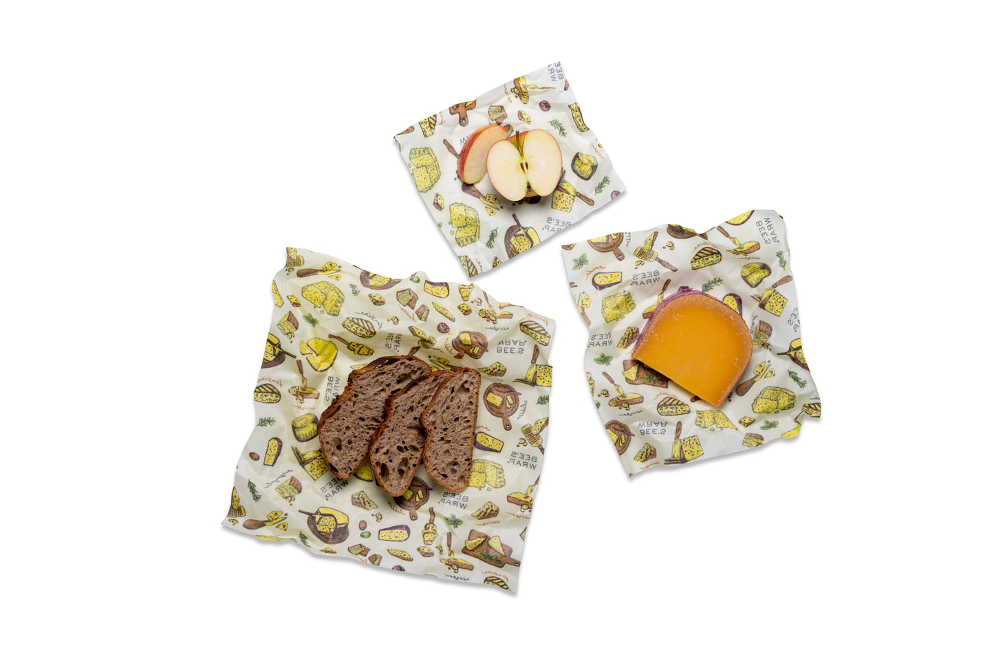 Three reusable wraps with Wheels n Wedges themed pattern, shown on a white background with food props: bread, apple slices, and cheese.