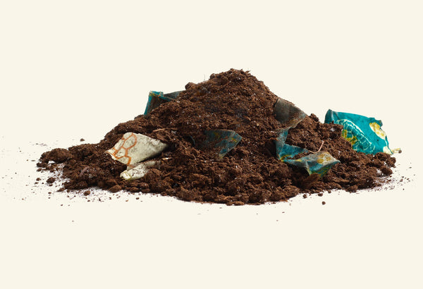 bee's wrap product mixed with pile of compost soil